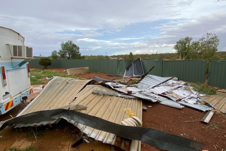 Piles of metal fencing next to a caravan