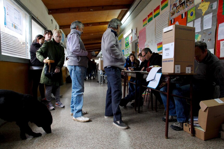 People line up to cast their votes at a polling station in Buenos Aires