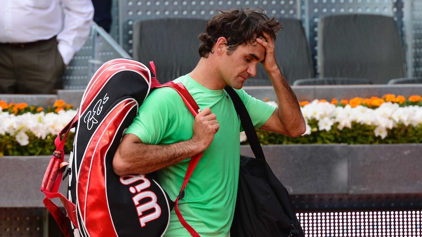 Early exit ... Roger Federer leaves the court after losing to Kei Nishikori