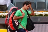 Early exit ... Roger Federer leaves the court after losing to Kei Nishikori