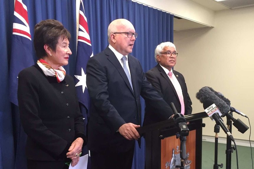 Margaret White and Mick Gooda flank Attorney-General George Brandis