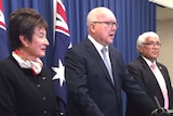 Margaret White and Mick Gooda flank Attorney-General George Brandis