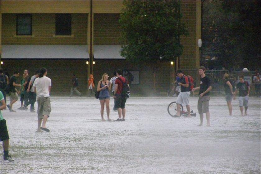 UWA students get in amongst the hail at the Crawley campus.