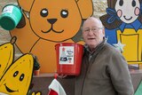 Tony Scott with a Giving Tree donation bucket, 2018