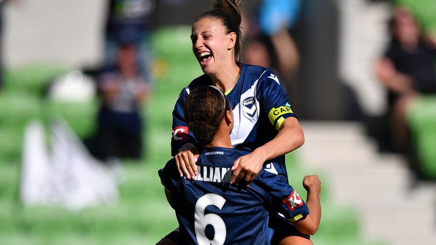Two Melbourne Victory A-League Women players celebrate a goal.