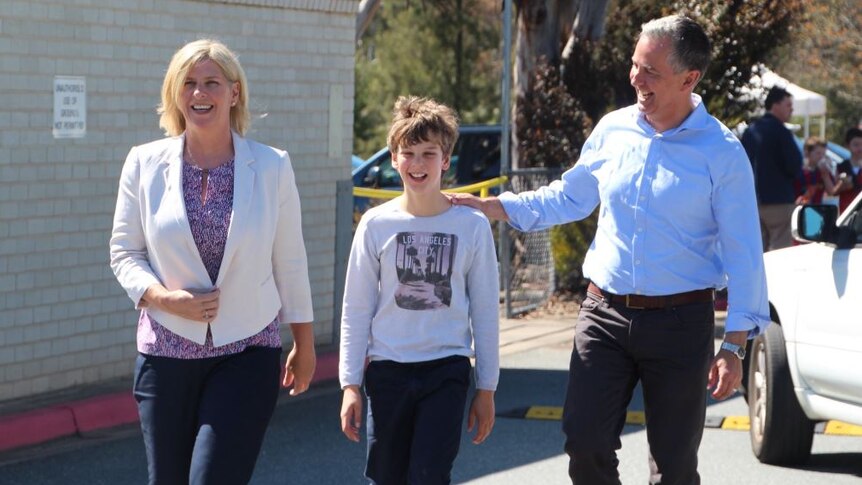 Liberal leader Jeremey Hanson walking with his family on their way to vote.