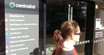 Woman walks past Centrelink office