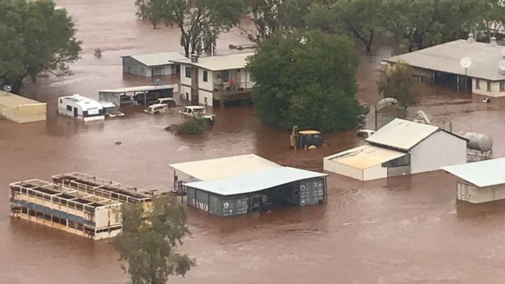 A vast cattle station submerged in water.