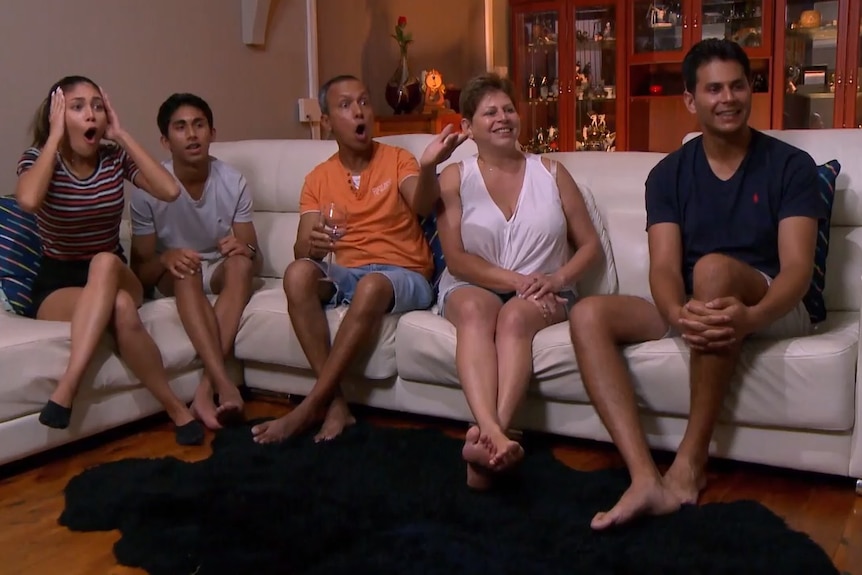 A reaction shot of a family on the couch from an episode of Googlebox Australia.