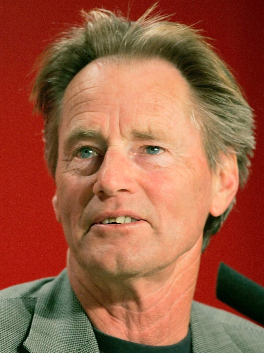 Close-up of actor Sam Shepard wearing t-shirt and coat.