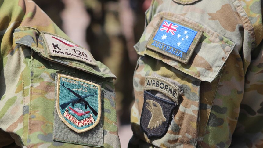 Patches on the uniforms of two Australian soldiers in Iraq