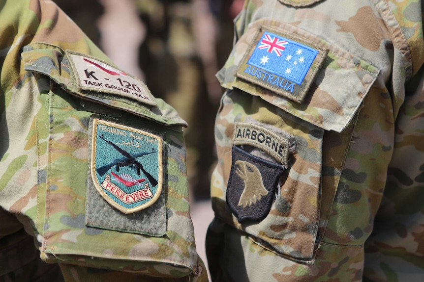 Patches on the uniforms of two Australian soldiers in Iraq