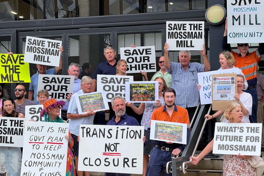 Group of protesters with placards that read transition not closure, save the mossmon mill, what's the future for mossman?