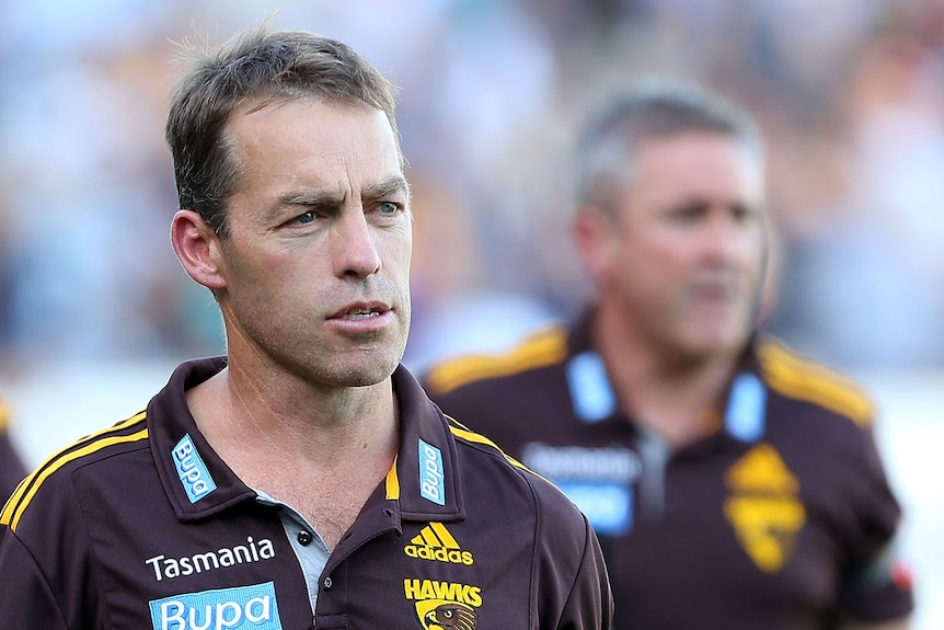 A man in a brown polo shirt.