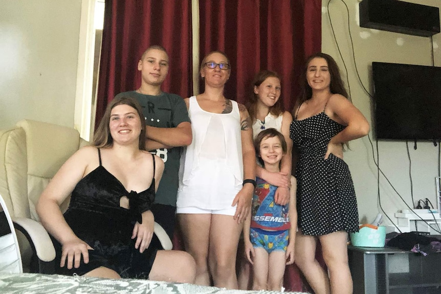 Brisbane mum Charli Lee (centre), surrounded by her own five children, decided at 31 to become an altruistic surrogate.