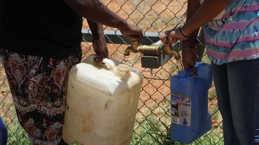 Melissa Morton (left) and Kelly McCormack at Yuelamu get water from a bore