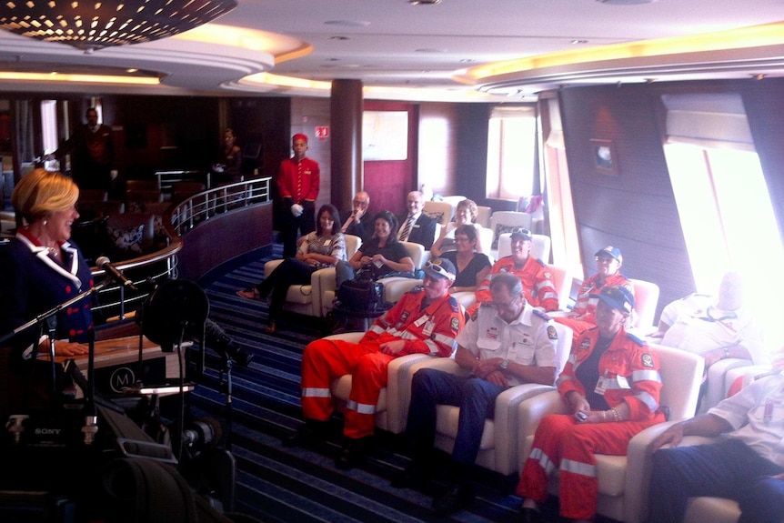 SES volunteers are greeted after boarding Queen Mary 2.