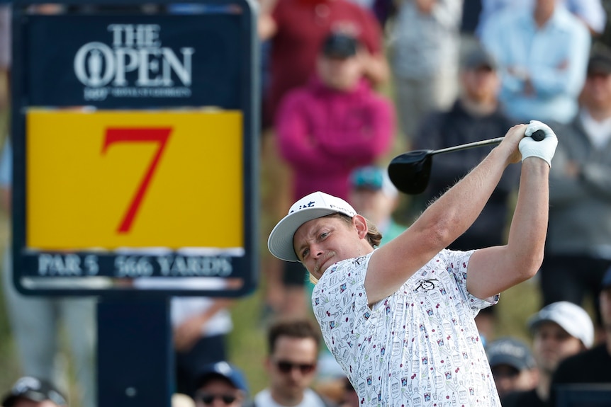A cap-wearing Australian golfer completes his swing on the seventh tee at Royal St Georges in The Open. 