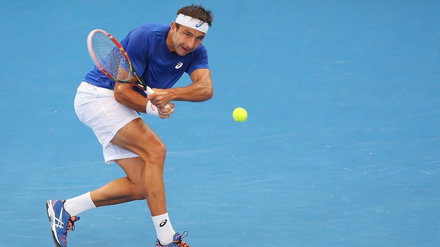 Marinko Matosevic backhands during Brisbane International loss