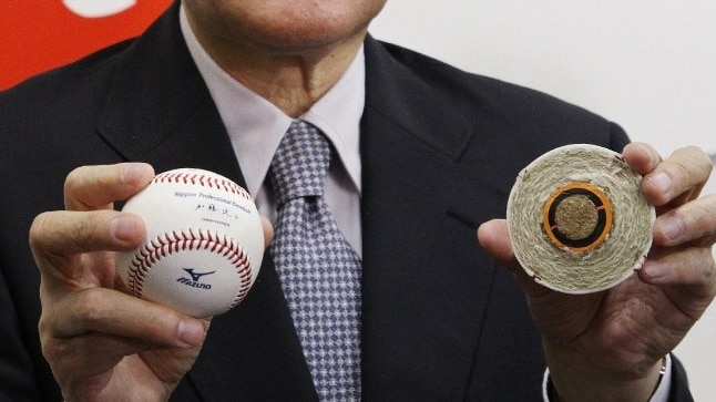 Nippon Professional Baseball commissioner Ryozo Kato holding an official ball