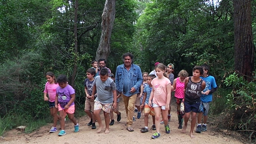 B.J. Cruse leading a tour group along the Bundian Way, an ancient Aboriginal pathway