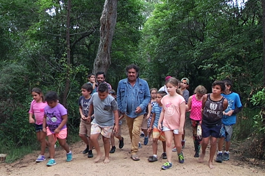 B.J. Cruse leading a tour group along the Bundian Way, an ancient Aboriginal pathway
