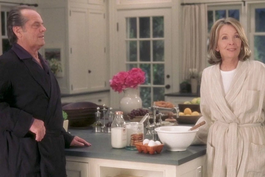 Jack Nicholson and Diane Keaton in a softly lit all-white Hamptons-style kitchen.