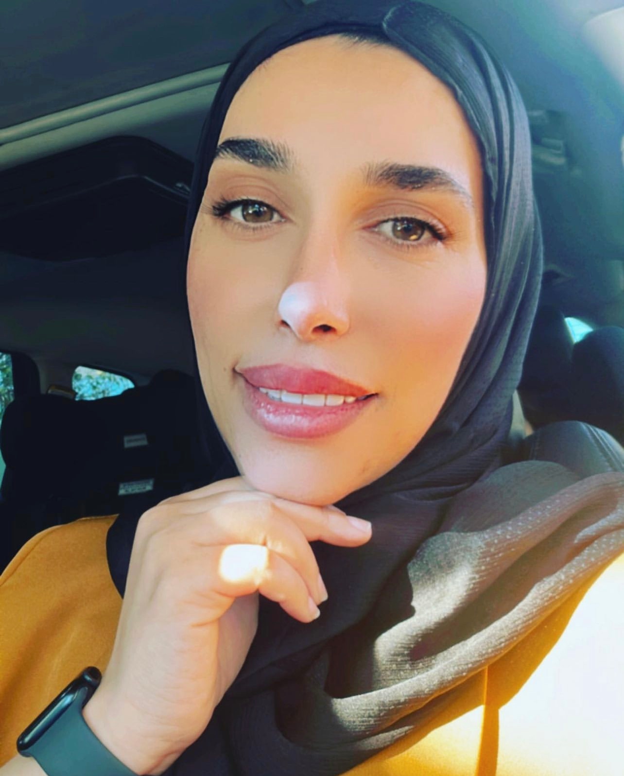 woman taking a selfie in a car