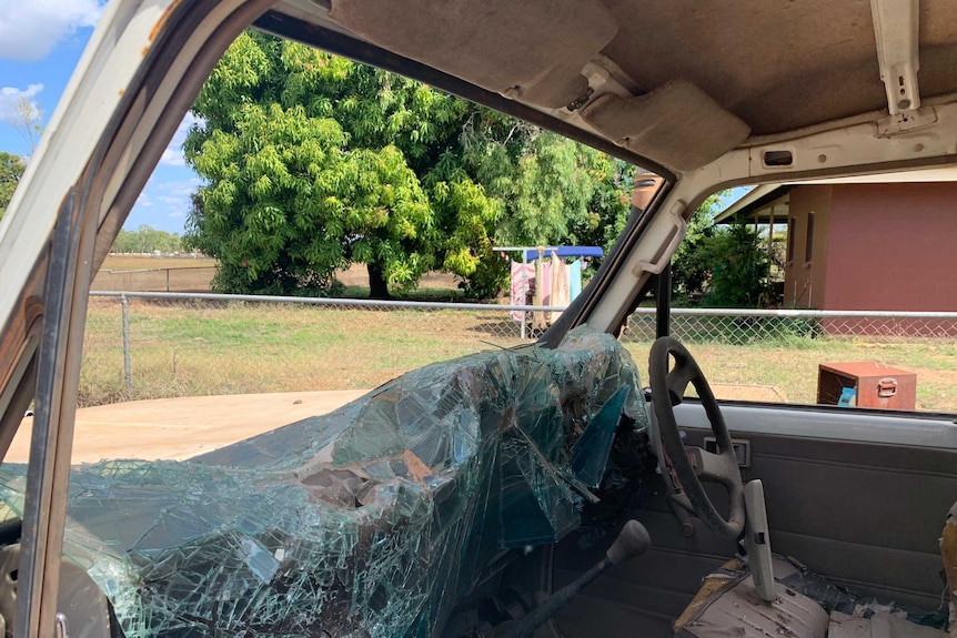 A window of a four wheel drive smashed in with glass on the seat.