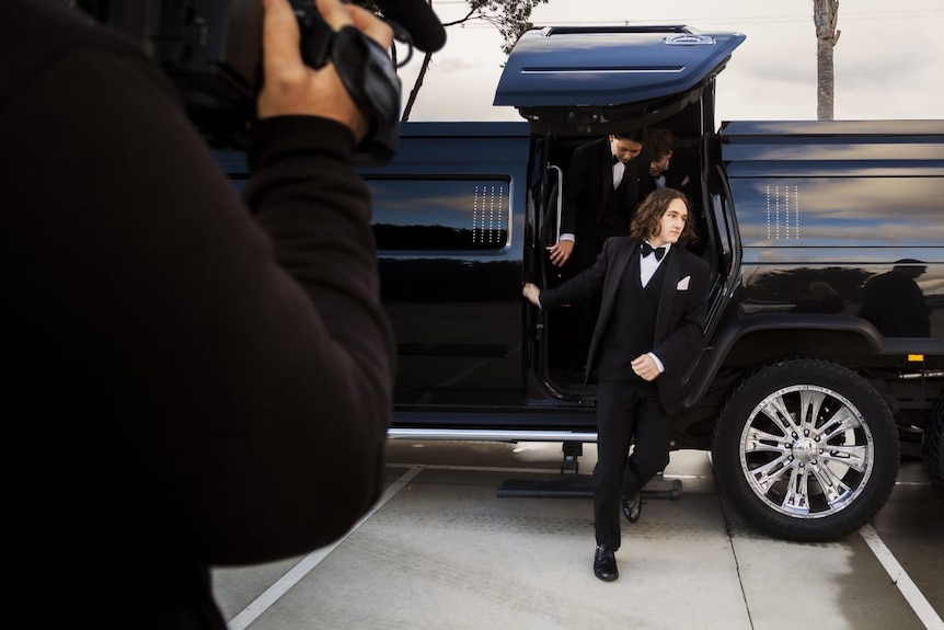 Reid Buygoyne strides out of a limousine outside the function centre