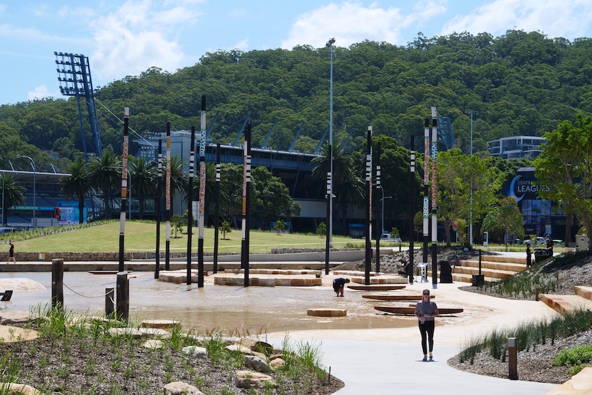 Indigenous artwork in the form of timber beams stand tall in the park