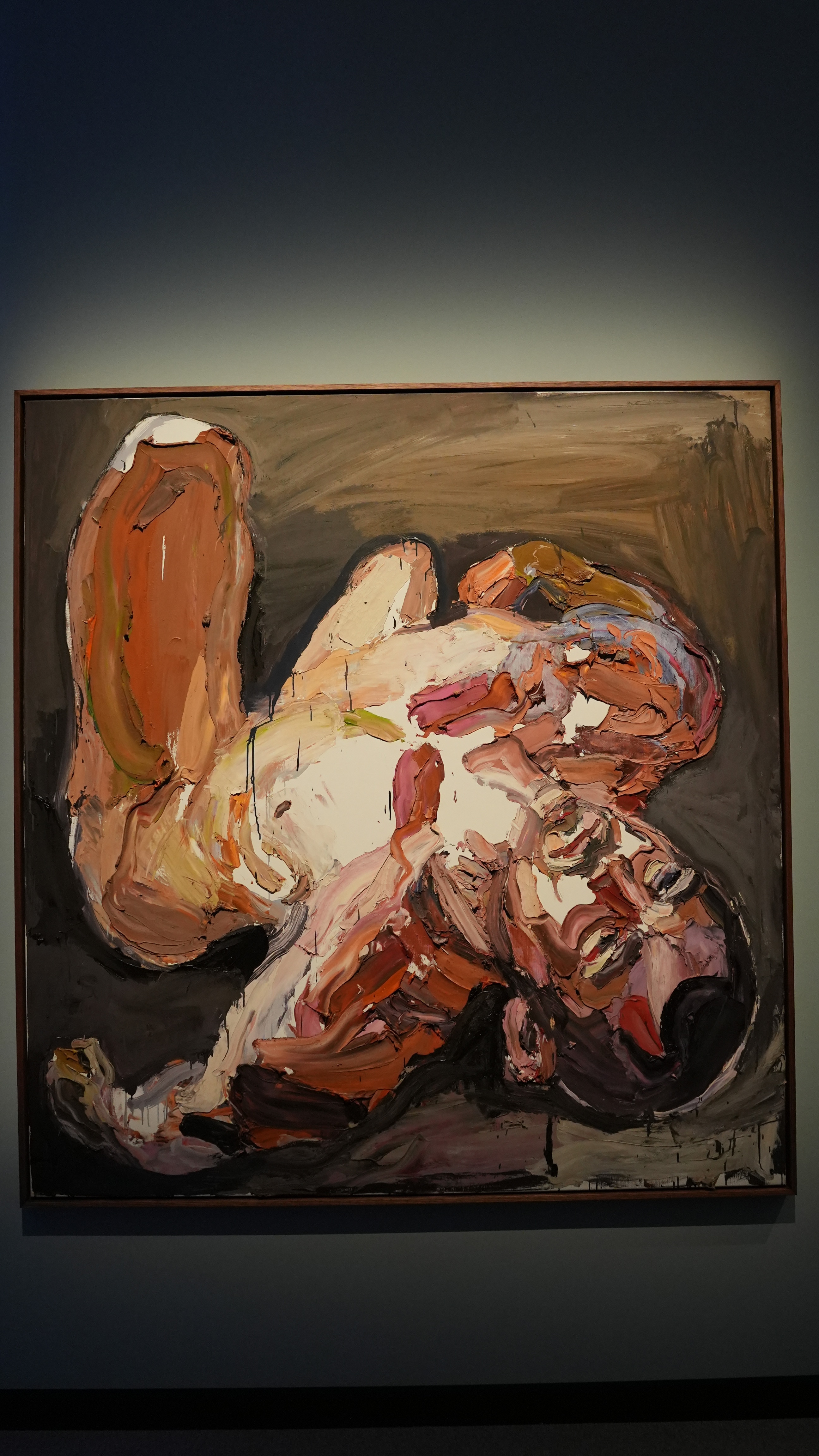 A painting of a man lying down, with strong colours and brushstrokes.