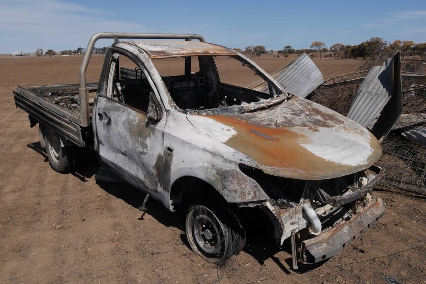 Burnt out ute in a paddock