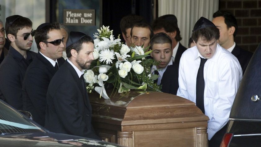 Pallbearers carry the casket of actor Corey Haim