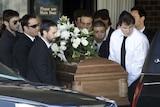 Pallbearers carry the casket of actor Corey Haim