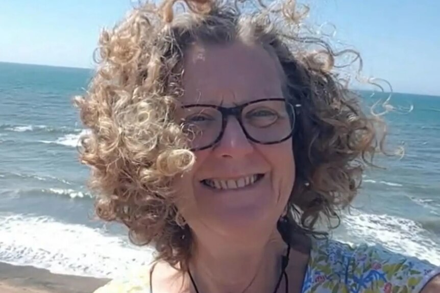 woman smiling on a beach selfie 