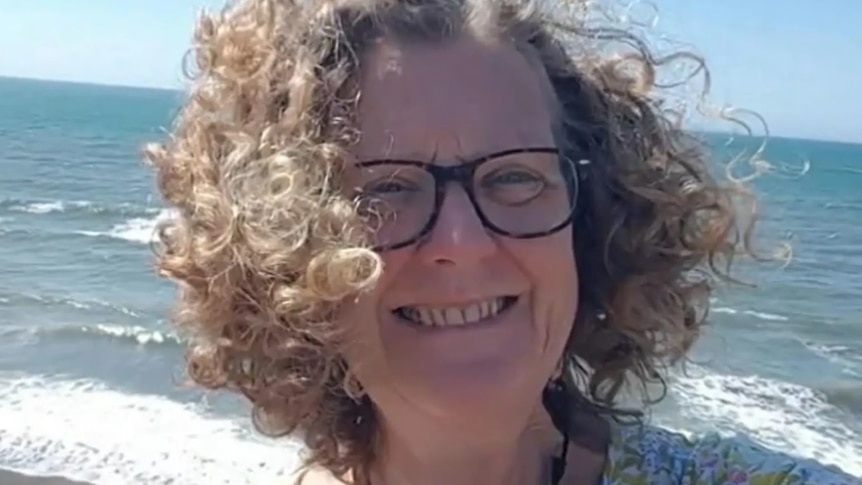 woman smiling on a beach selfie 