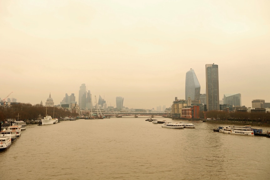 A view of the London cityscape with an orange sky.