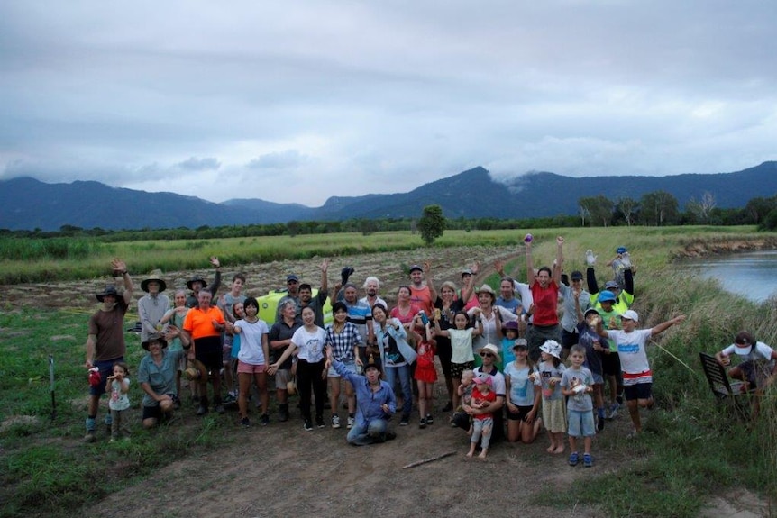 Group of people on a community planting day in former cane field.