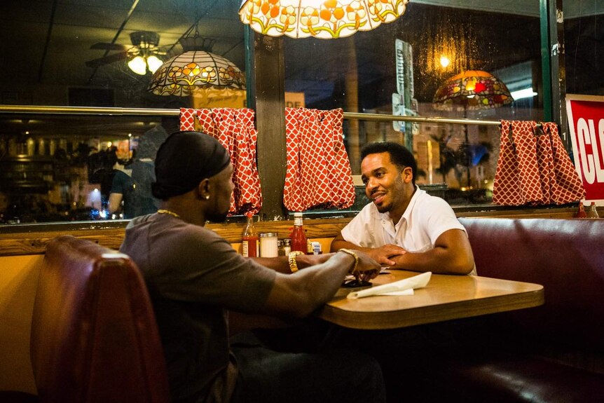 André Holland and Trevante Rhodes in a diner in a scene from Moonlight.