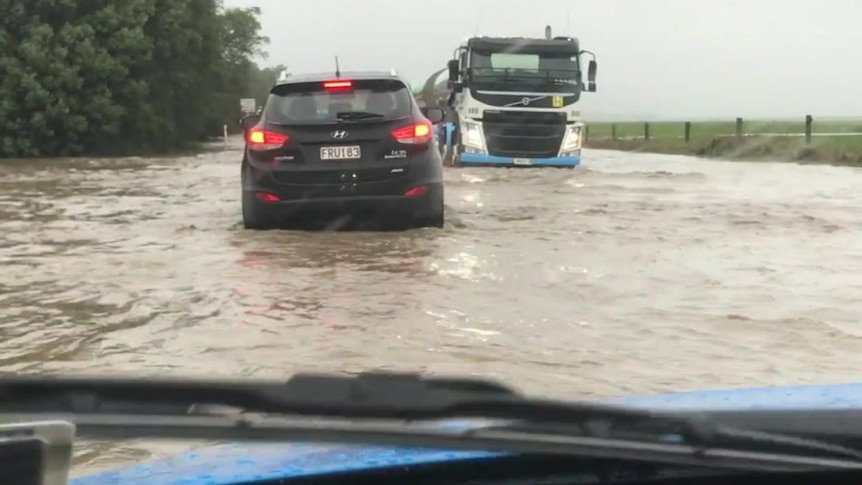 Motorists brave a flooded state highway near Dunsandel in New Zealand