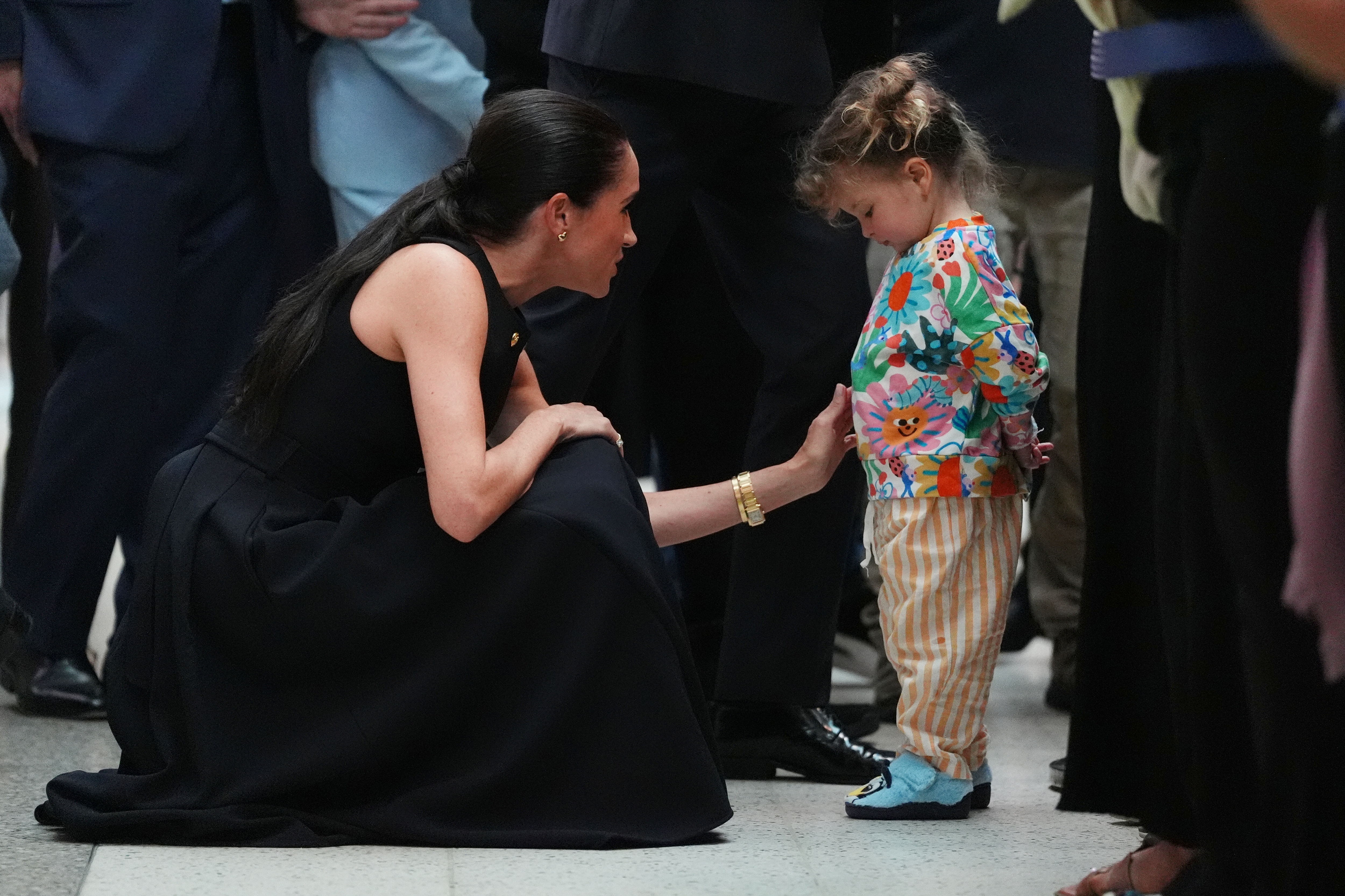 Meghan Markle talking to a young girl