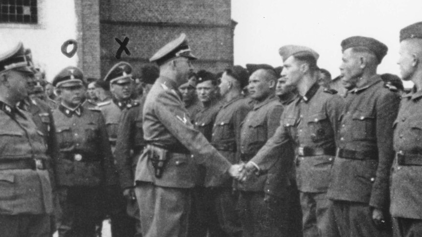 Heinrich Himmler (Centre left) shakes hands with new recruits at the Trawniki concentration camp.