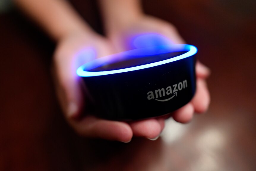 a child holds an echo dot in outstretch hands
