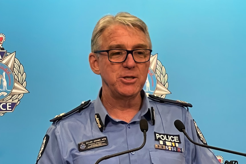 A police officer at a lectern speaking