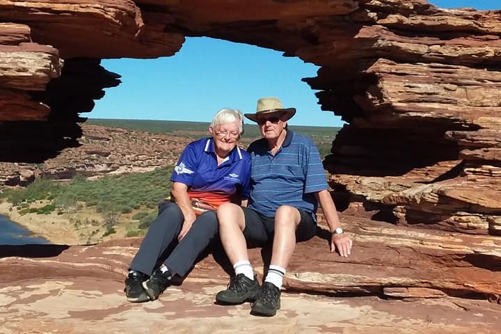 A couple sit in the rock formation called Nature's Window