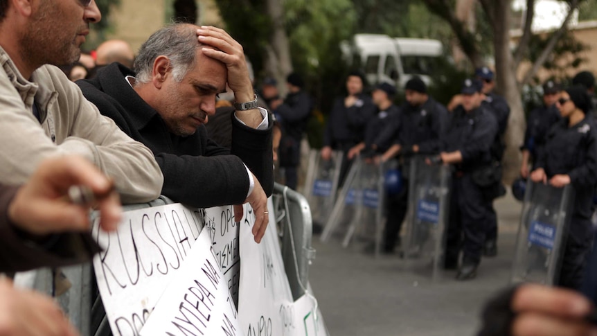 Cypriots wait for a final EU bailout deal