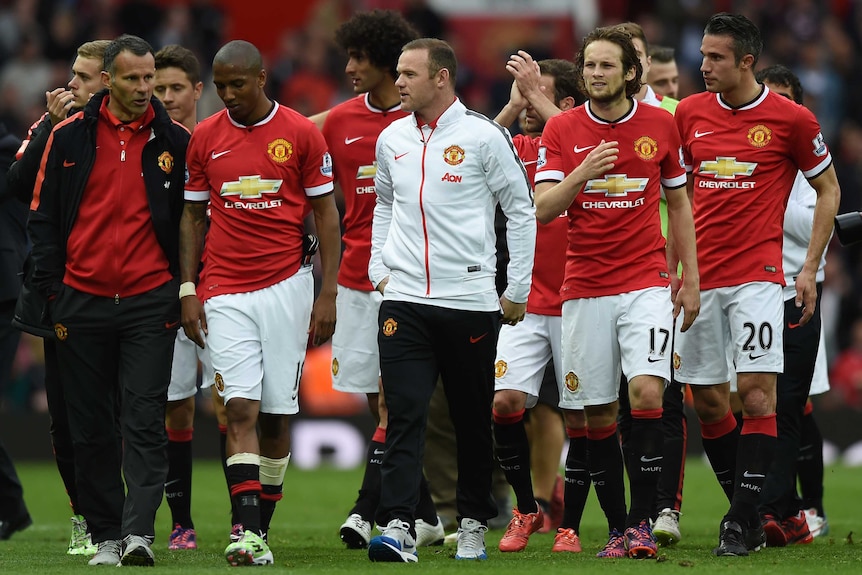 Wayne Rooney leads Manchester United around Old Trafford