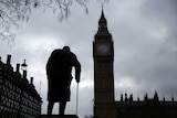 A statue of Winston Churchill in front of the Houses of Parliament in London.
