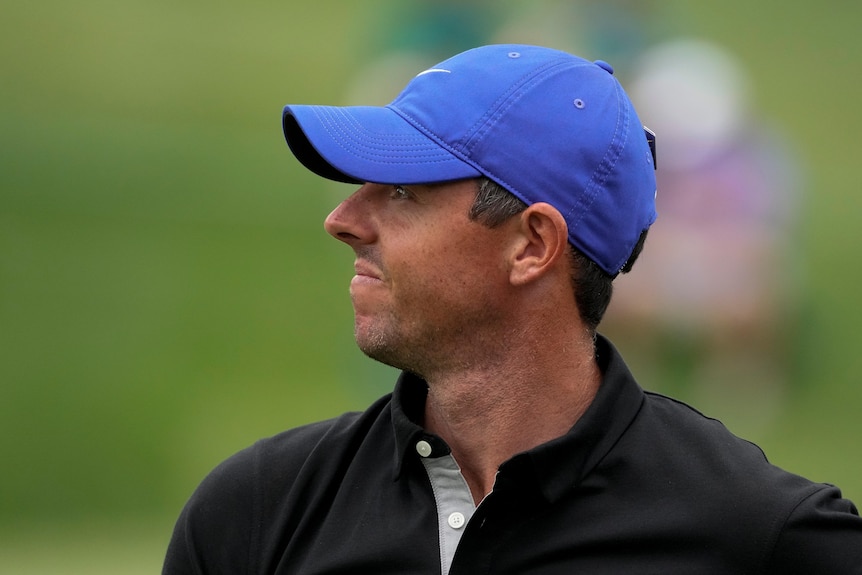 A golfer stares down the fairway after hitting his drive on day one of the Masters.